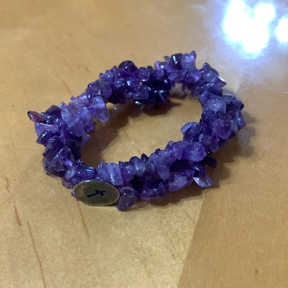 Amethyst in color w cross and words.